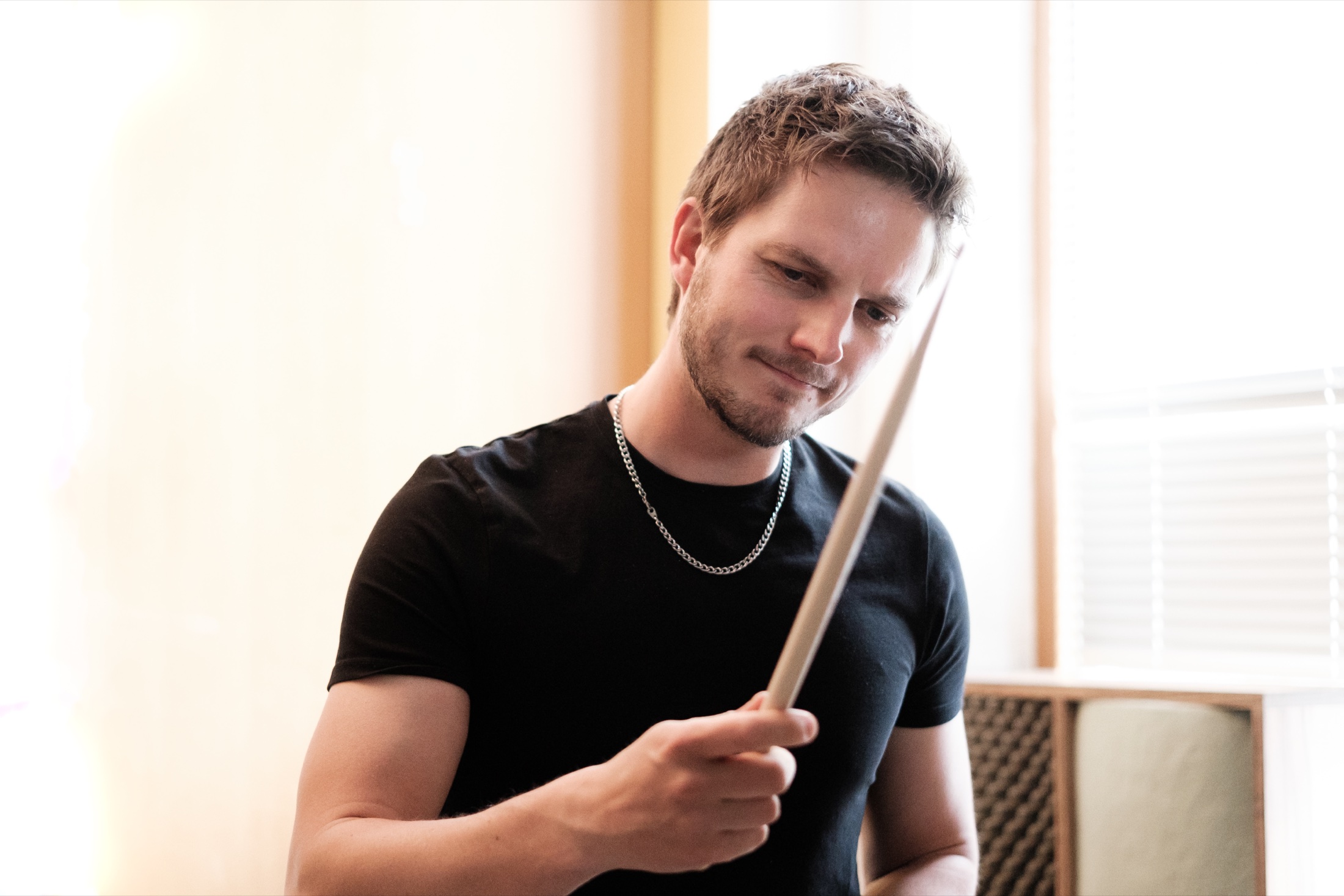 Portrait of Christoph Pfister with a drumstick